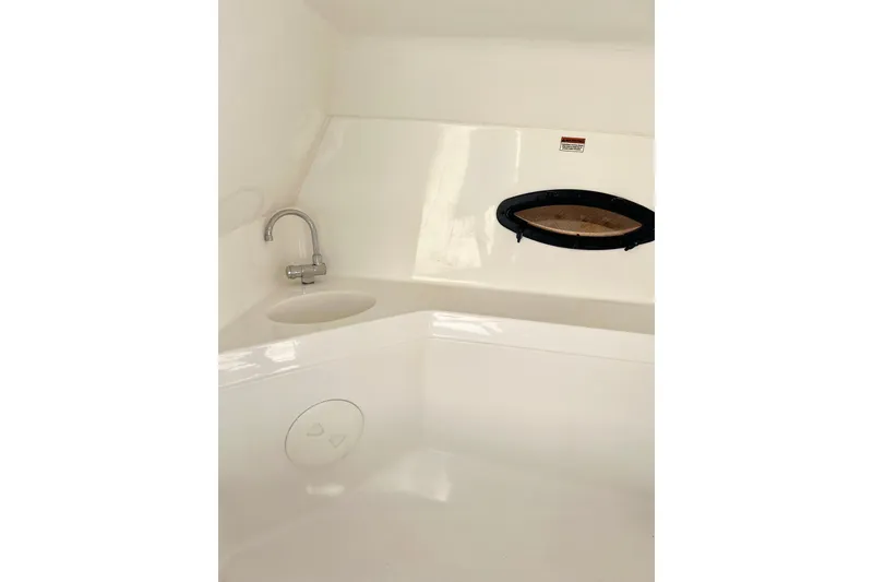 Slide: The Image of 2013 Hurricane SunDeck 2200 OB boat interior with sink and porthole. - 36