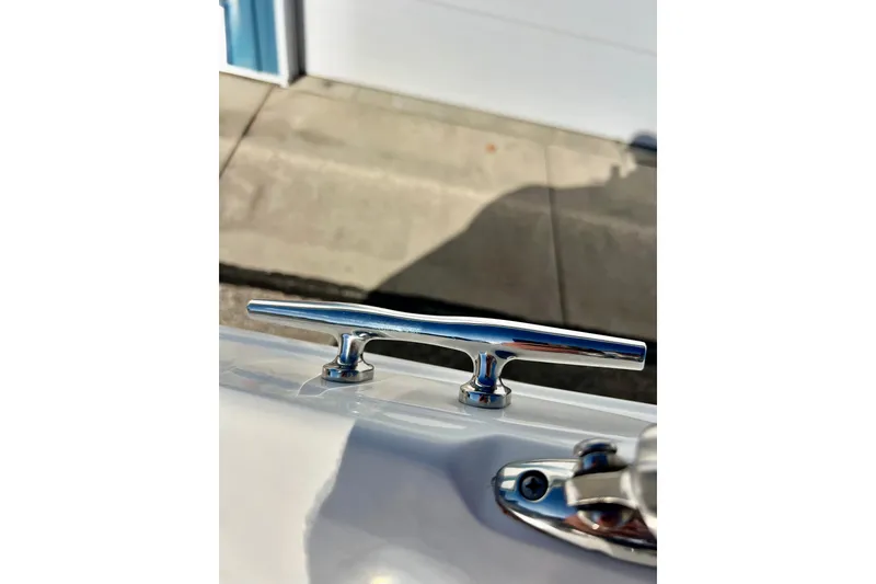 Slide: The Image of Chrome cleat on 2013 Hurricane SunDeck 2200 OB boat, dockside view. - 45
