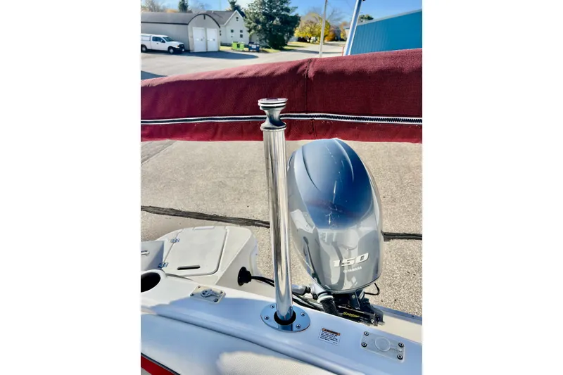 Slide: The Image of 2013 Hurricane SunDeck 2200 OB boat with Yamaha 150 outboard motor and red canopy. - 65