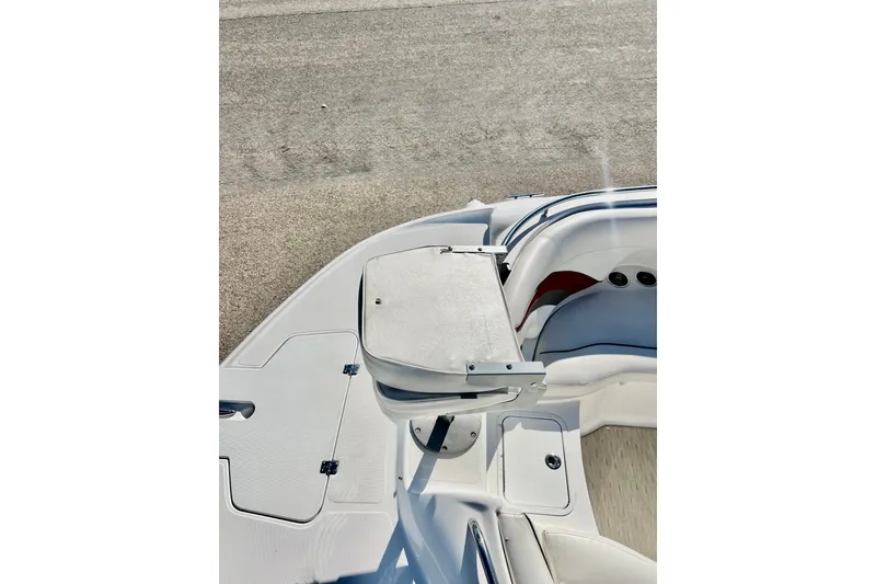 Slide: The Image of 2013 Hurricane SunDeck 2200 OB boat interior with seating and storage compartments. - 55