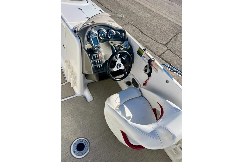 Slide: The Image of 2013 Hurricane SunDeck 2200 OB boat cockpit with steering wheel and control panel. - 15