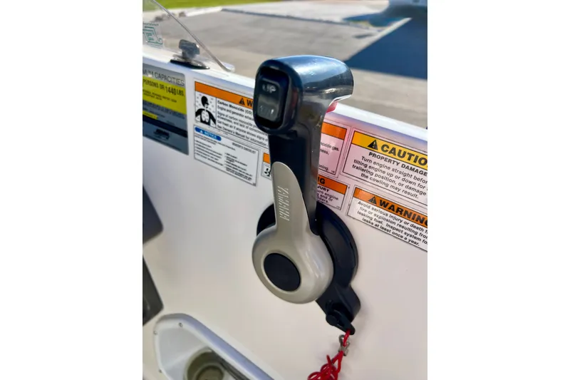 Slide: The Image of Throttle control on a 2013 Hurricane SunDeck 2200 OB boat with safety warnings. - 19