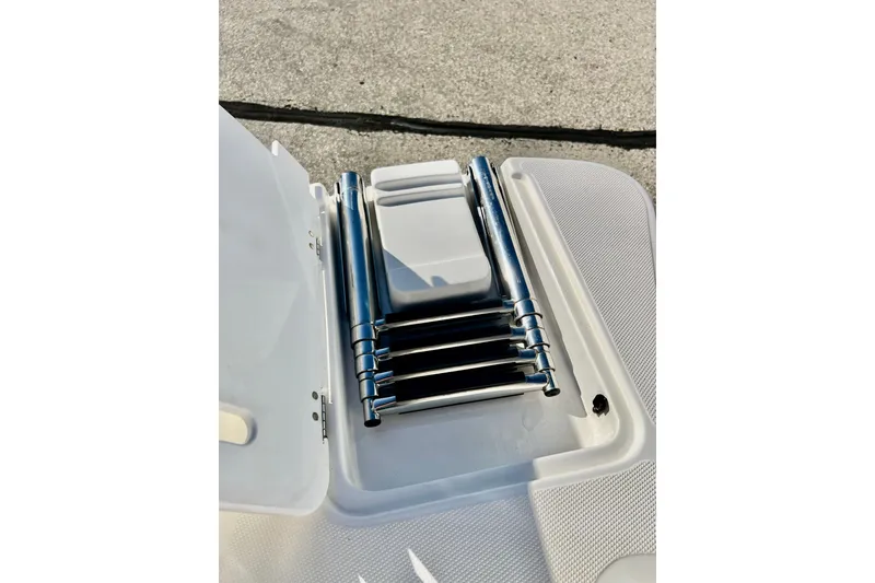 Slide: The Image of 2013 Hurricane SunDeck 2200 OB boat ladder, folded on deck. - 42