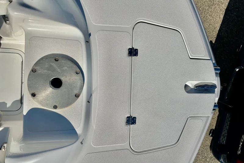 Slide: The Image of 2013 Hurricane SunDeck 2200 OB boat deck with storage hatch and metal fixture. - 56
