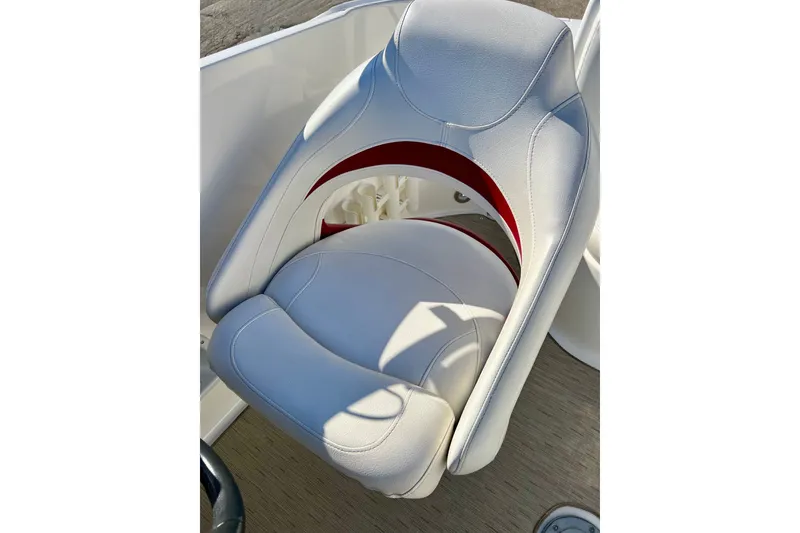 Slide: The Image of 2013 Hurricane SunDeck 2200 OB boat seat, white with red accents, close-up view. - 21