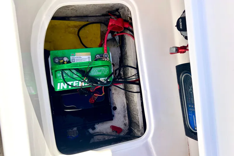 Slide: The Image of Battery compartment of 2013 Hurricane SunDeck 2200 OB boat with wiring and connections. - 26