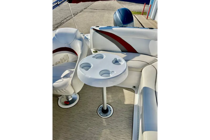 Slide: The Image of 2013 Hurricane SunDeck 2200 OB boat interior with seating and cup holder table. - 40