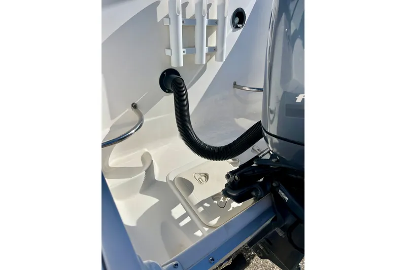 Slide: The Image of 2013 Hurricane SunDeck 2200 OB boat engine compartment with hose and fittings. - 13