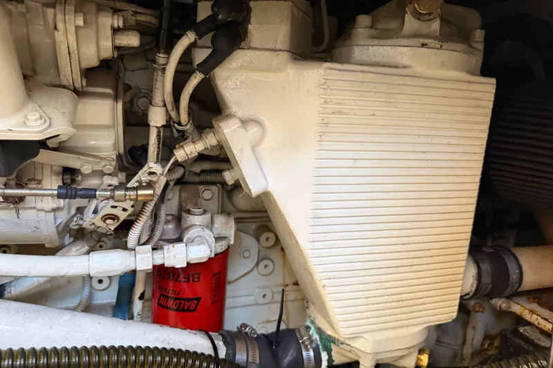 Slide: The Image of Engine compartment of a 2000 Bayliner 4788 Pilot House Motoryacht, showcasing mechanical components. - 56