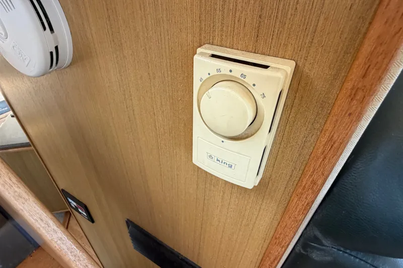 Slide: The Image of Thermostat on 2000 Bayliner 4788 Pilot House Motoryacht wooden interior wall. - 38