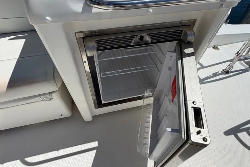 Slide: The Image of Open mini fridge on 2000 Bayliner 4788 Pilot House Motoryacht deck. - 24