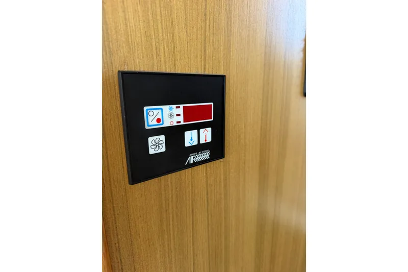 Slide: The Image of Control panel on 2000 Bayliner 4788 Pilot House Motoryacht, featuring fan and temperature settings. - 59