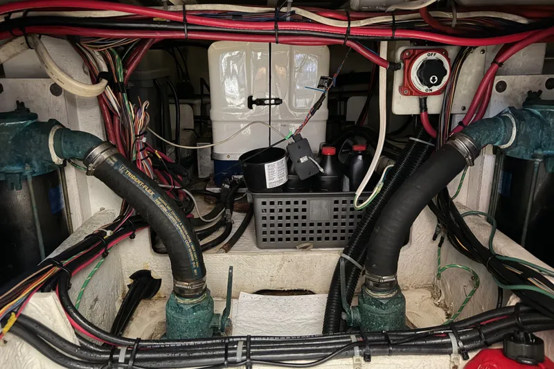 Slide: The Image of Engine room of a 2000 Bayliner 4788 Pilot House Motoryacht with wiring and hoses visible. - 58