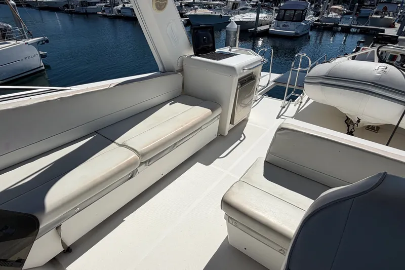 Slide: The Image of 2000 Bayliner 4788 Pilot House Motoryacht deck with seating and marina view. - 22