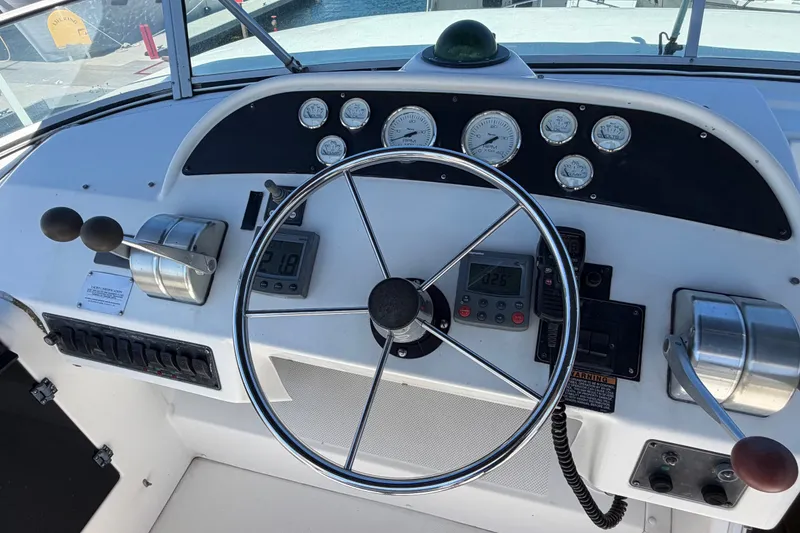 Slide: The Image of Cockpit of 2000 Bayliner 4788 Pilot House Motoryacht with steering wheel and control panel. - 20