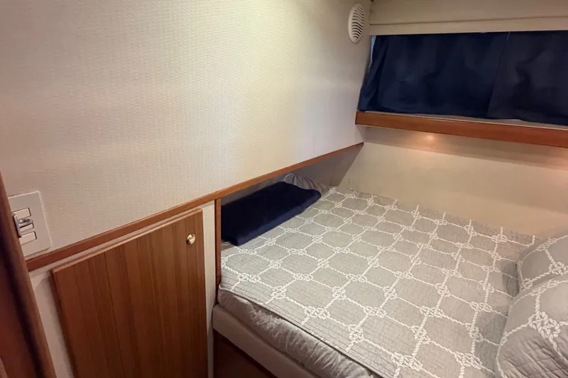 Slide: The Image of Cozy cabin interior of 2000 Bayliner 4788 Pilot House Motoryacht with bed and wooden accents. - 41