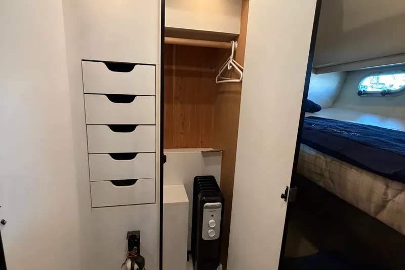 Slide: The Image of Interior of 2000 Bayliner 4788 yacht showing closet and bedroom area. - 53