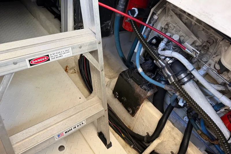 Slide: The Image of Engine room of 2000 Bayliner 4788 Pilot House Motoryacht with ladder and mechanical components. - 55