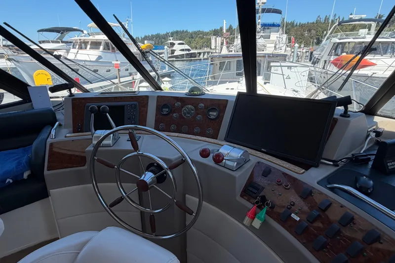 Slide: The Image of Cockpit of 2000 Bayliner 4788 Pilot House Motoryacht with steering wheel and navigation controls. - 34