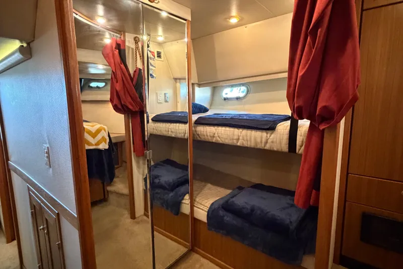Slide: The Image of Interior of 2000 Bayliner 4788 Pilot House Motoryacht with cozy bunk beds and mirrored closet. - 54