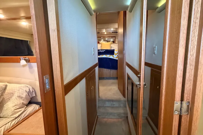 Slide: The Image of Interior hallway of 2000 Bayliner 4788 Pilot House Motoryacht, featuring cozy cabin and wood accents. - 44