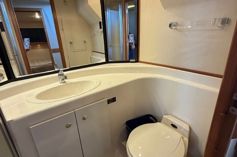 Slide: The Image of Bathroom interior of 2000 Bayliner 4788 Pilot House Motoryacht, featuring sink and toilet. - 42