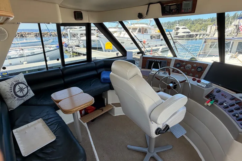 Slide: The Image of Interior of 2000 Bayliner 4788 Pilot House Motoryacht with helm and seating area. - 33