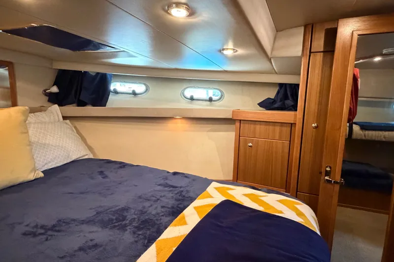 Slide: The Image of Luxurious cabin interior of 2000 Bayliner 4788 Pilot House Motoryacht with cozy bedding. - 48