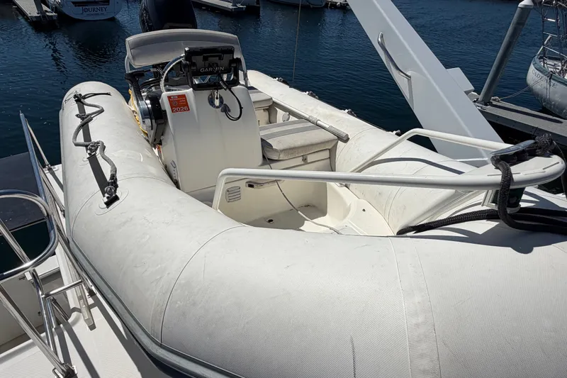 Slide: The Image of Inflatable boat on Bayliner 4788 Pilot House Motoryacht, 2000 model, docked at marina. - 13