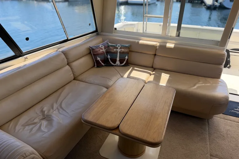 Slide: The Image of Luxurious interior of 2000 Bayliner 4788 Pilot House Motoryacht with beige leather seating. - 27
