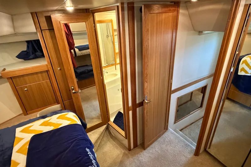 Slide: The Image of Interior of 2000 Bayliner 4788 Pilot House Motoryacht with wood paneling and cozy cabin. - 50