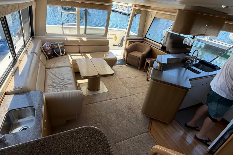 Slide: The Image of Luxurious interior of 2000 Bayliner 4788 Pilot House Motoryacht with spacious seating and kitchen area. - 32