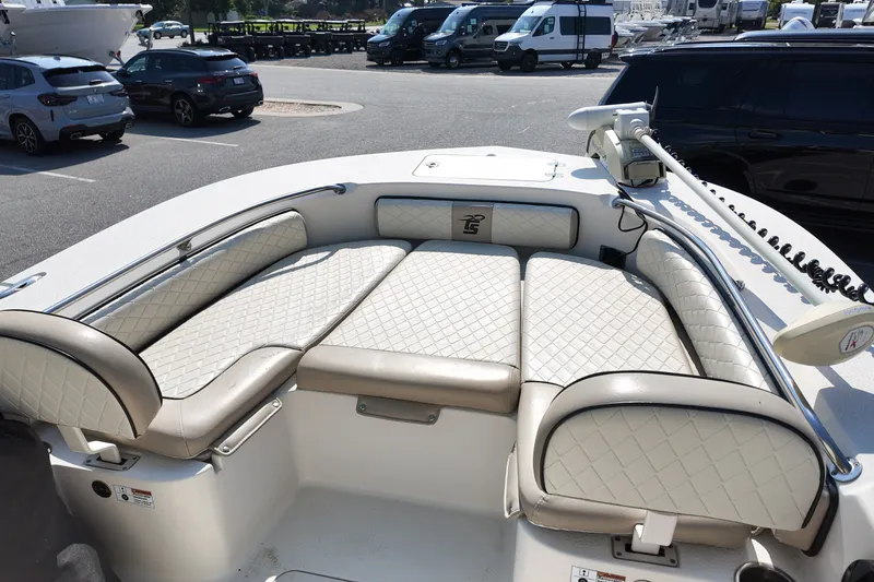 Slide: The Image of 2021 Carolina Skiff 24 Ultra Elite boat with cushioned seating and trolling motor. - 16