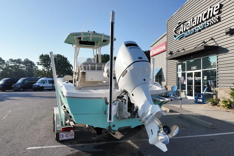 Slide: The Image of 2021 Carolina Skiff 24 Ultra Elite boat with outboard motor at dealership. - 2