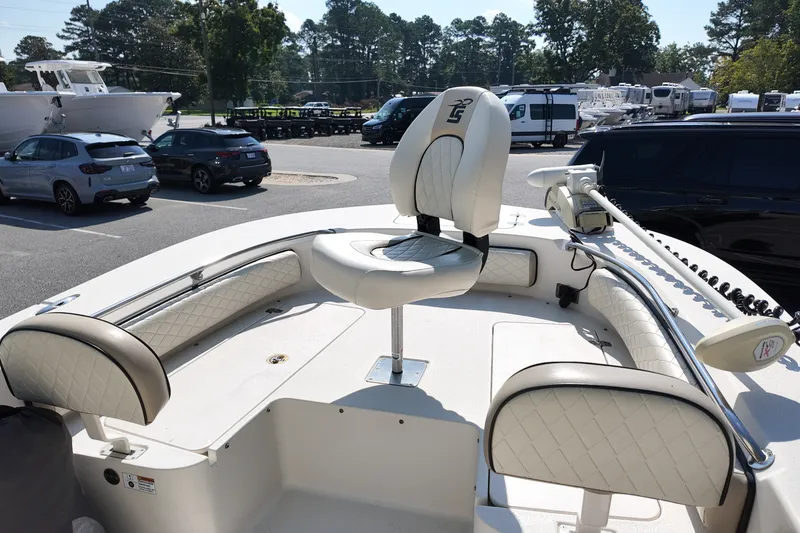 Slide: The Image of 2021 Carolina Skiff 24 Ultra Elite boat interior with cushioned seating and steering console. - 20