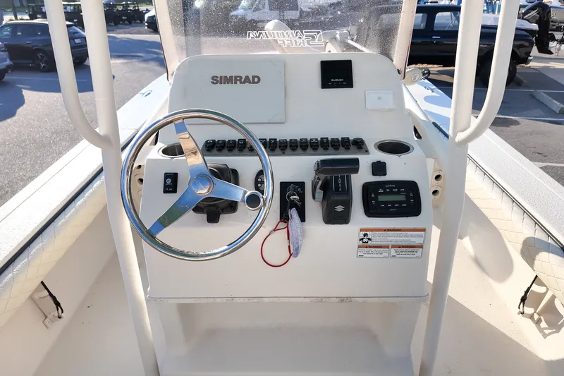 Slide: The Image of 2021 Carolina Skiff 24 Ultra Elite boat console with steering wheel and controls. - 14