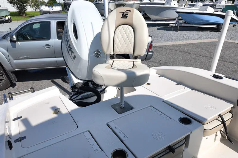 Slide: The Image of 2021 Carolina Skiff 24 Ultra Elite boat with Suzuki engine, featuring a comfortable captain's chair. - 17