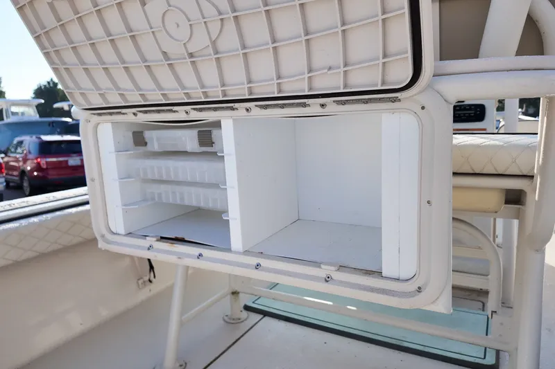 Slide: The Image of 2021 Carolina Skiff 24 Ultra Elite boat storage compartment open, showcasing interior space. - 11