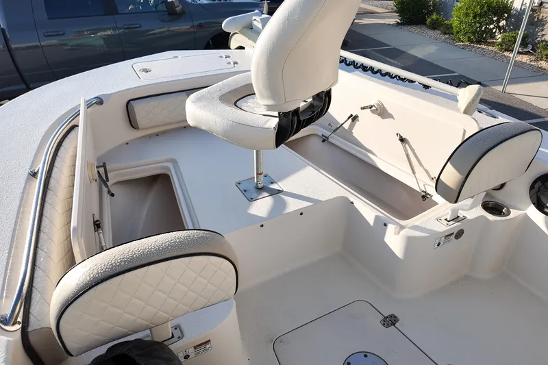 Slide: The Image of 2021 Carolina Skiff 24 Ultra Elite boat interior with seating and storage compartments. - 7