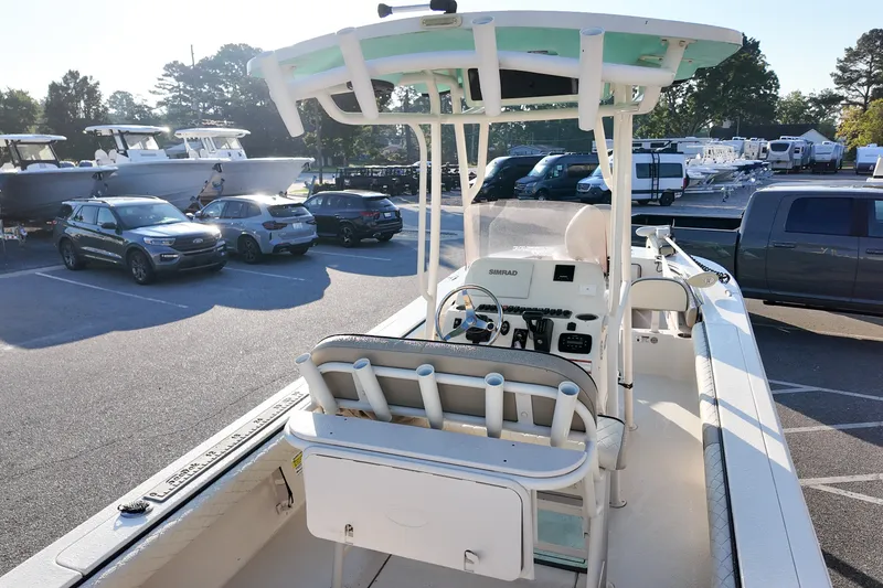 Slide: The Image of 2021 Carolina Skiff 24 Ultra Elite boat in parking lot, surrounded by vehicles. - 6