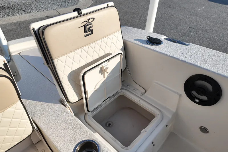 Slide: The Image of 2021 Carolina Skiff 24 Ultra Elite boat seat with storage compartment open. - 10