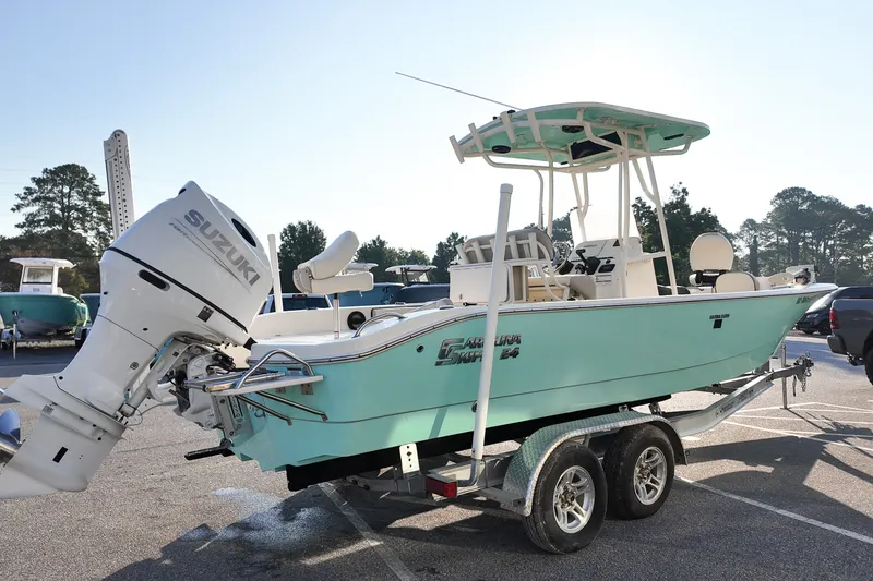 Slide: The Image of 2021 Carolina Skiff 24 Ultra Elite boat on trailer with Suzuki outboard motor. - 3