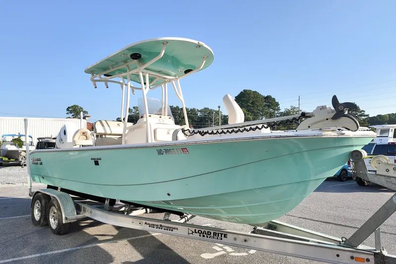 Slide: The Image of 2021 Carolina Skiff 24 Ultra Elite boat on trailer, light blue hull, sunny day. - 5