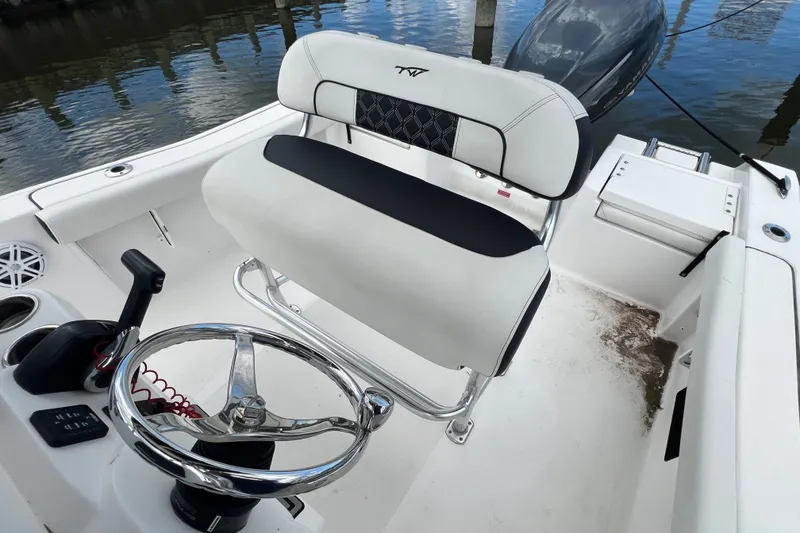 Slide: The Image of 2021 Tidewater 198 CC Adventure boat interior with steering wheel and seating. - 8