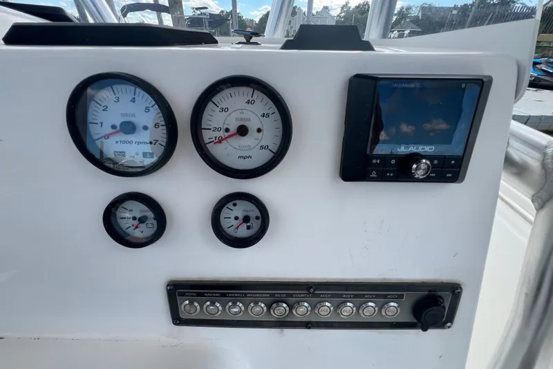 Slide: The Image of Dashboard of 2021 Tidewater 198 CC Adventure boat with gauges and JL Audio system. - 17