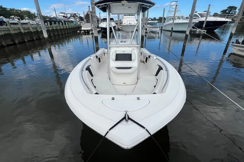 Slide: The Image of 2021 Tidewater 198 CC Adventure boat docked in a marina, front view. - 3