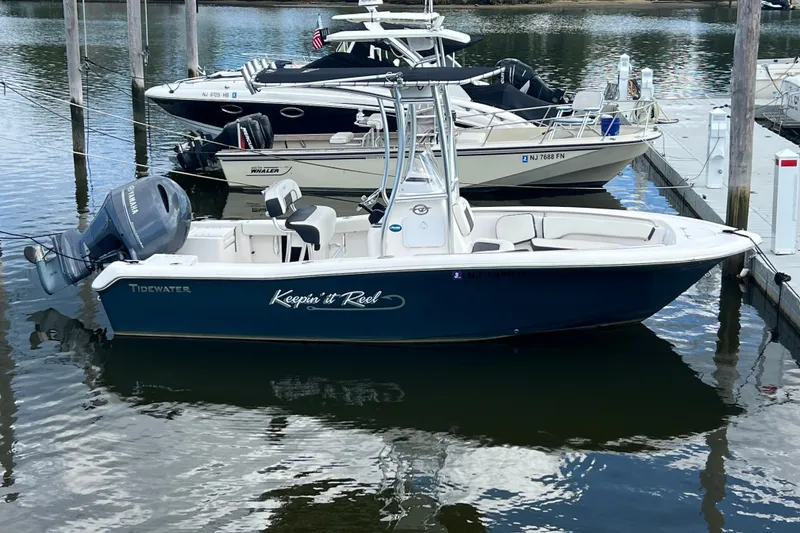 The Image of 2021 Tidewater 198 CC Adventure boat docked in marina, featuring Yamaha outboard motor. - 0