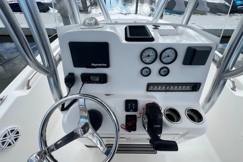 Slide: The Image of 2021 Tidewater 198 CC Adventure boat dashboard with steering wheel and gauges. - 12