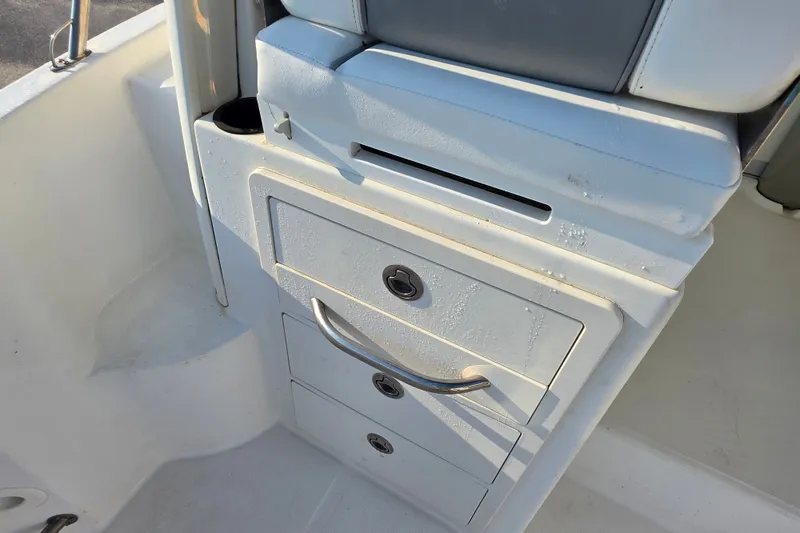 Slide: The Image of 2012 Boston Whaler 285 Conquest boat interior storage compartment with drawers. - 17