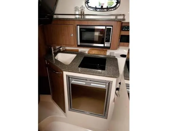 Slide: The Image of Manufacturer Provided Image: 2012 Boston Whaler 285 Conquest boat kitchen with microwave, sink, and mini-fridge. - 18